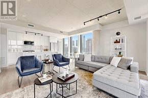 Toronto (Moss Park) condo for rent - A living room with a grey sofa, two chairs and a coffee table.