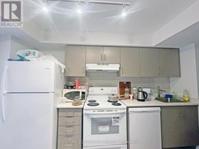 Toronto (Kensington-Chinatown) condo for rent - A kitchen with white appliances and a white refrigerator.