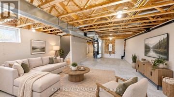 Casselman townhouse for rent - A living room with a couch, a coffee table, and a painting on the wall.