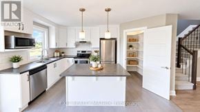 Casselman townhouse for rent - A kitchen with white cabinets and a black countertop.