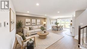 Casselman townhouse for rent - A well-lit, modern living room with a dining area in the background.
