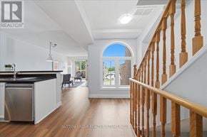 Mississauga (Hurontario) townhouse for rent - A modern kitchen with a stainless steel dishwasher and wooden flooring.