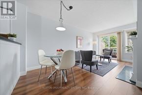 Mississauga (Hurontario) townhouse for rent - A modern dining room with a glass table and chairs.