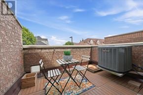 Mississauga (Hurontario) townhouse for rent - A patio with a table and chairs and a brick wall.