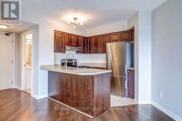 Mississauga (Hurontario) condo for rent - A kitchen with a wooden island and cabinets.