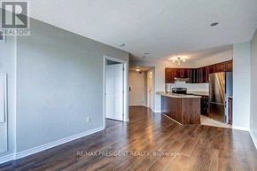 Mississauga (Hurontario) condo for rent - A spacious living room with a kitchen in the background.