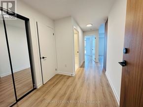 Brampton (Northwest Brampton) condo for rent - A hallway with wooden floors and white walls.