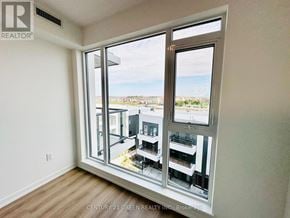 Brampton (Northwest Brampton) condo for rent - A room with a view of a beach and buildings outside the window.