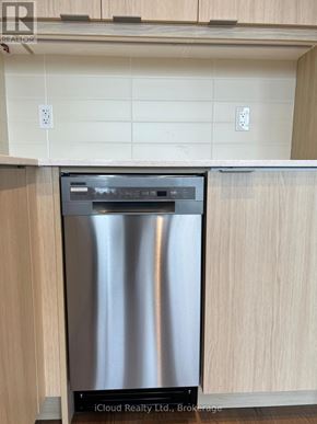 Milton (Tm Timberlea) condo for rent - A stainless steel dishwasher in a kitchen with wooden cabinets.