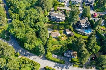 Surrey apartment for rent - A bird's eye view of a residential area with houses, trees, and a pool.