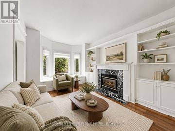 Newmarket (Summerhill Estates) apartment for rent - A living room with a fireplace and a painting on the wall.