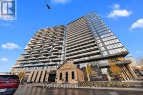 Ottawa condo for rent - A tall building with a glass facade stands next to a smaller, older structure.