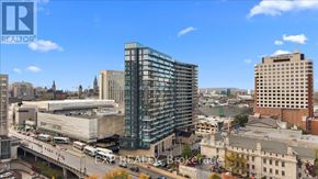 Ottawa condo for rent - A cityscape with a modern glass building in the center.