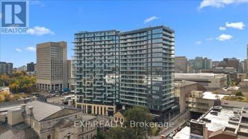 Ottawa condo for rent - A tall building with many windows is the focal point of the image.