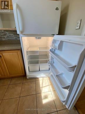 Mississauga (Malton) apartment for rent - A white refrigerator with its door open in a kitchen.