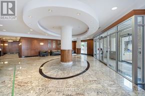 Ottawa condo for rent - A large, open lobby with a marble floor and a central column.