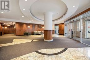 Ottawa condo for rent - A large, open lobby with a marble floor and a central column.