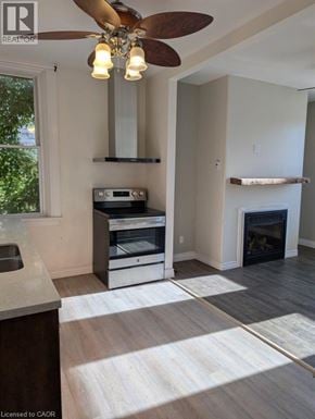 Brantford apartment for rent - A modern kitchen with a fan and a fireplace.