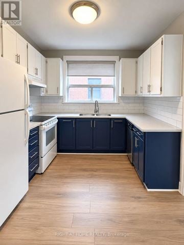 Toronto (Casa Loma) apartment for rent - A kitchen with white cabinets and a white refrigerator.