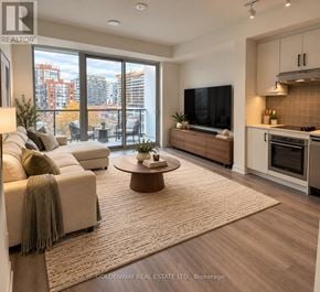 Toronto (Niagara) condo for rent - A living room with a couch, a coffee table, and a television.