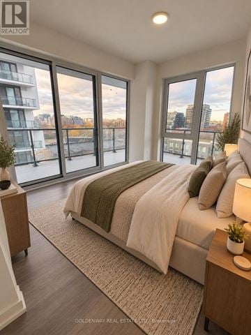 Toronto (Niagara) condo for rent - A bedroom with a large bed and a view of the city.