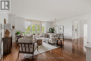 Toronto (The Beaches) condo for rent - A well-lit, spacious living room with a sofa set, a coffee table, and a large window.