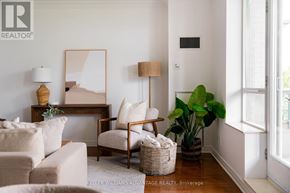 Toronto (The Beaches) condo for rent - A living room with a couch, chair, and a painting on the wall.