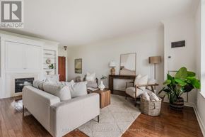 Toronto (The Beaches) condo for rent - A living room with a grey couch, a wooden coffee table, and a large mirror on the wall.