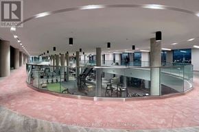 Vaughan (Vaughan Corporate Centre) condo for rent - A large atrium with a glass wall and a circular floor.