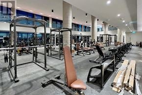 Vaughan (Vaughan Corporate Centre) condo for rent - A gym with a variety of equipment including weight machines and free weights.
