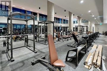 Vaughan (Vaughan Corporate Centre) condo for rent - A gym with a variety of equipment including weight machines and free weights.