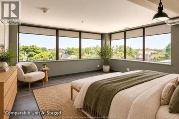 Windsor apartment for rent - A bedroom with a large bed and a view of the outdoors.