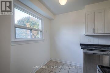 Toronto (Agincourt South-Malvern West) townhouse for rent - A kitchen area with a window and a stove top oven.