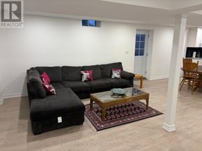 Richmond Hill (Oak Ridges Lake Wilcox) apartment for rent - A living room with a black couch and ottoman.