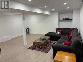 Richmond Hill (Oak Ridges Lake Wilcox) apartment for rent - A living room with a black couch and a wooden coffee table.