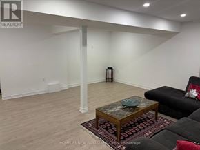 Richmond Hill (Oak Ridges Lake Wilcox) apartment for rent - A living room with a black couch and a wooden coffee table.