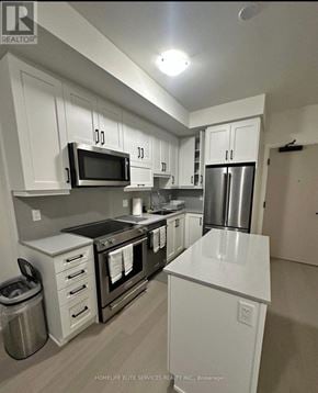 Oakville (Jm Joshua Meadows) condo for rent - A kitchen with white cabinets and stainless steel appliances.