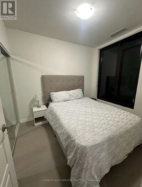 Oakville (Jm Joshua Meadows) condo for rent - A bedroom with a bed, nightstand, and lamp.