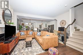 Niagara-On-The-Lake (Town) townhouse for rent - A living room with a brown couch and a television.