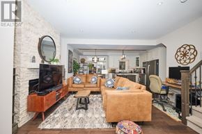 Niagara-On-The-Lake (Town) townhouse for rent - A living room with a couch, a television, and a fireplace.