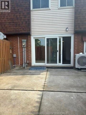 Windsor townhouse for rent - A house with a Realty sign on the wall.