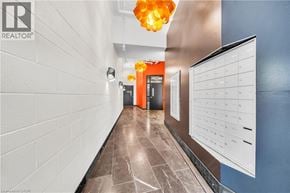 Hamilton condo for rent - A hallway with a white wall and a calendar on the wall.