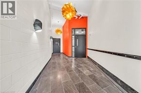 Hamilton condo for rent - A hallway with a red accent wall and a black door.