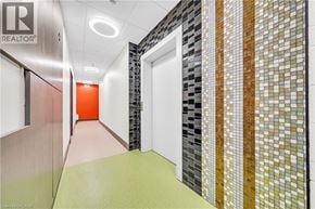 Hamilton condo for rent - A hallway with a green floor and a mosaic tile wall.