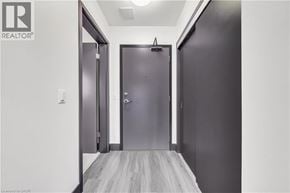Hamilton condo for rent - A hallway with two doors and a wooden floor.