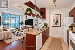 Toronto (Waterfront Communities) condo for rent - A modern kitchen with a wooden island and white appliances.