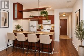 Toronto (Waterfront Communities) condo for rent - A kitchen with a bar area and chairs.
