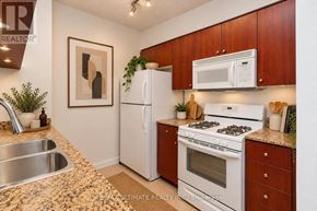 Toronto (Waterfront Communities) condo for rent - A kitchen with a stove, refrigerator, and sink.