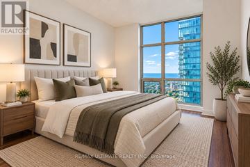 Toronto (Waterfront Communities) condo for rent - A bedroom with a large bed and a view of the city.
