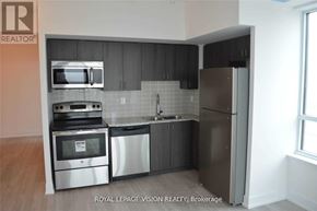 Pickering (Bay Ridges) condo for rent - A kitchen with a stainless steel refrigerator, oven, and microwave.